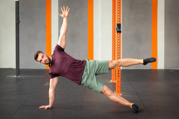 istock Flexible man performing calisthenics star side plank exercise in 2148339155