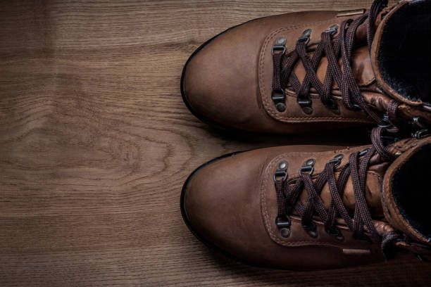 istock Brown nubuck boots on wood 2148339665