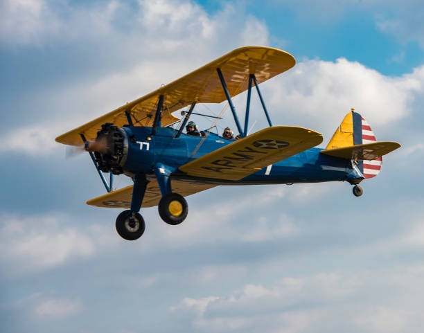 A beautifully restored Steersman PT-17 trainer aircraft, this one in the livery of the early 1940’s, flies by at Massey Aerodrome, a small grass field on Maryland’s Eastern Shore