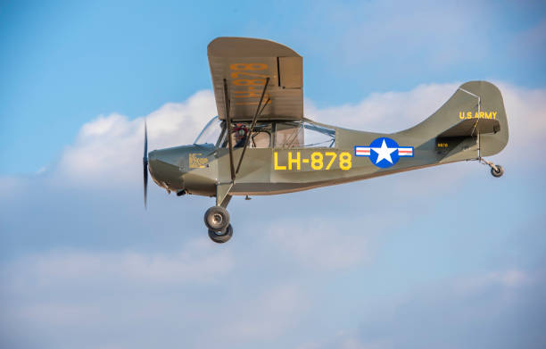 A beautifully restored L-4 Grasshopper flies by at Massey Aerodrome, a small grass field on Maryland’s Eastern Shore.The L-4 Grasshopper is a light observation and liaison aircraft that served with distinction during World War II. Developed by Piper Aircraft Corporation, the L-4 Grasshopper was a militarized version of the Piper J-3 Cub, a popular civilian aircraft of the era.The primary role of the L-4 Grasshopper was observation, reconnaissance, and liaison duties. It was used for artillery spotting, aerial photography, courier missions, and communication tasks, providing vital support to ground troops.The L-4 Grasshopper saw extensive service during World War II, serving with the U.S. Army Air Forces, the U.S. Navy (as the NE-1), and other Allied air forces. It played a vital role in numerous campaigns, including the D-Day invasion of Normandy, the Battle of the Bulge, and the Pacific island-hopping campaign.