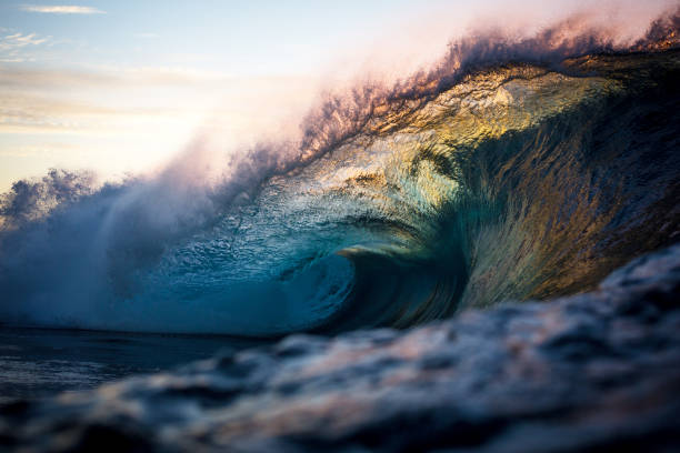 istock Powerful coloured wave curling over reef on sunrise 2148343013