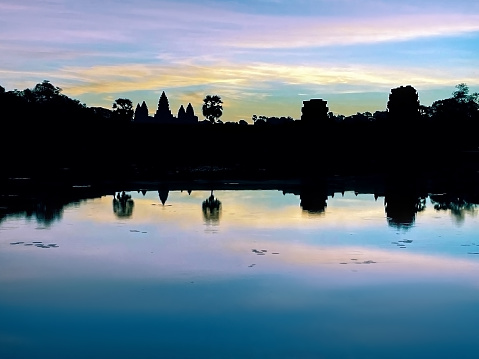 Ancient Thai temple with water reflection at Sukthai historical park at dusk