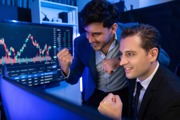 istock Successful two stock exchange traders raising fist up. Sellable. 2148343271