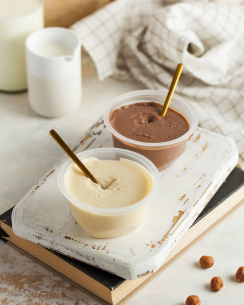 istock Vanilla and chocolate mousse desserts with golden spoons 2148343457