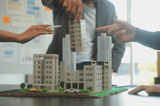 istock Team of architectures and businessmen discussing and brainstorming on floor plan modification for real estate investment and housing development project 2148344609