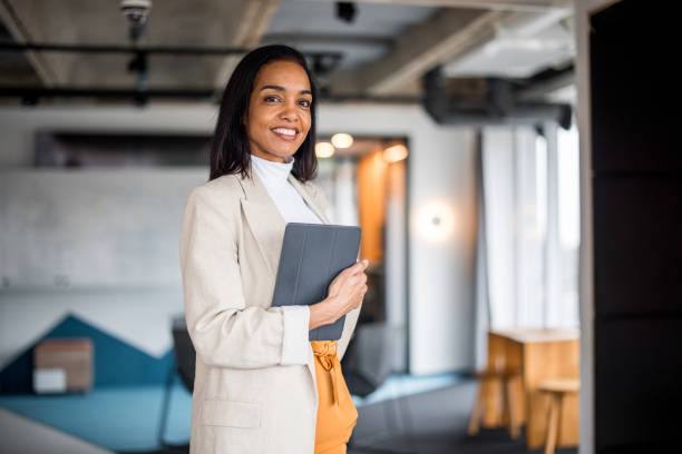 istock Confident Hispanic Businesswoman with Tablet in Office Setting 2148345379