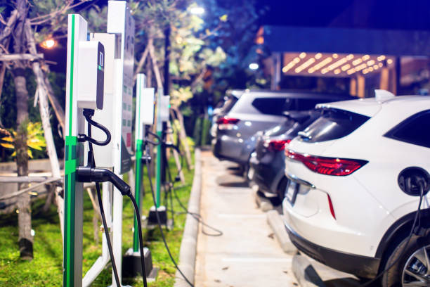 istock EV charging station with blurry an electric car. Power supply for electric car charging. Socket for electrical car battery charger. EV car charging station in parking. 2148347815