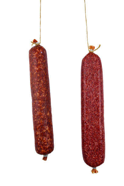 istock Two hanging raw smoked sausage isolated on white background 2148350278