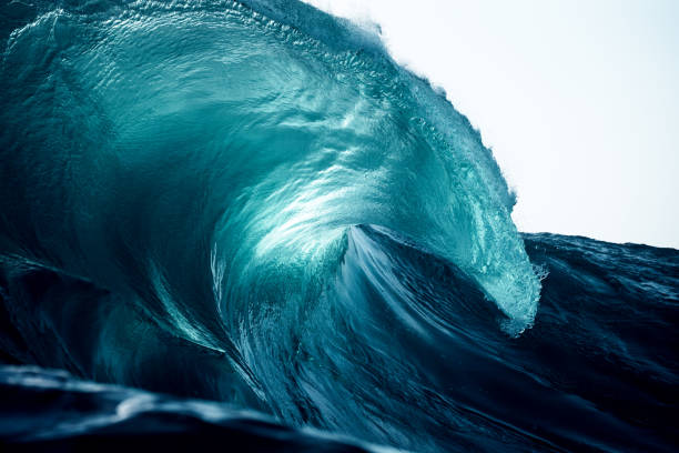 istock Sunlight fills the vortex of a heavy curling wave 2148350706