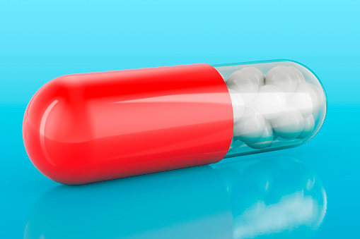 Medicament capsule on blue backdrop, 3D rendering