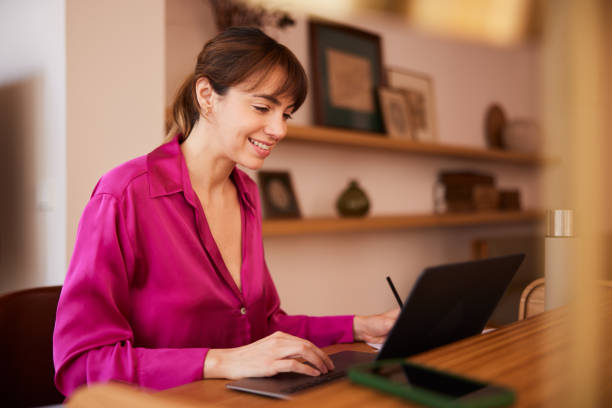 istock Workstation Focus: Businesswoman Typing Intently on Laptop 2148351924