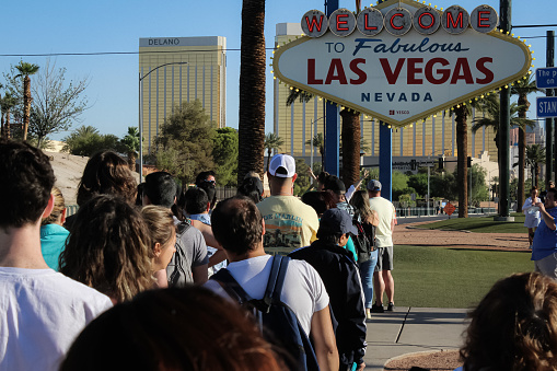 People line up to take photos with an Elvis Presley impersonator