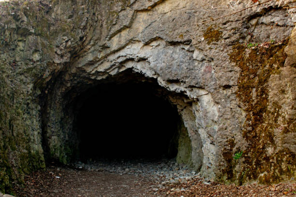 istock entrance to a dark cave 2148352302