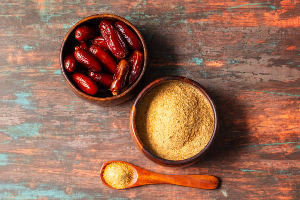 istock selective focus of dates with dates sugar on wooden bowls. 2148353468