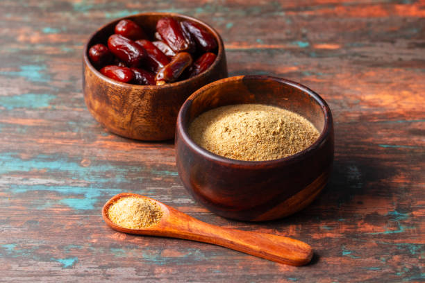 istock selective focus of dates with dates sugar on wooden bowls. 2148353472