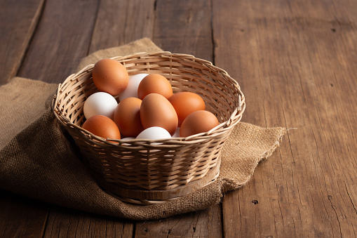 Close up of Basket of chicken eggs on a wooden table