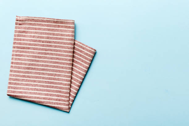 istock top view with red empty kitchen napkin isolated on table background. Folded cloth for mockup with copy space, Flat lay. Minimal style 2148354810