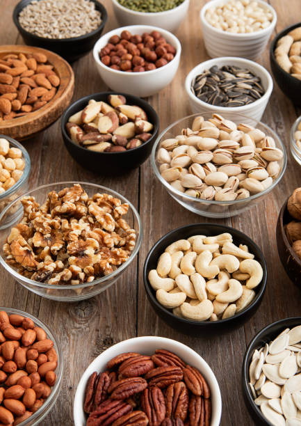 istock Raw walnuts and cashew with almonds and peanuts with organic nuts and seed in various assorted bowls.Macro 2148355194