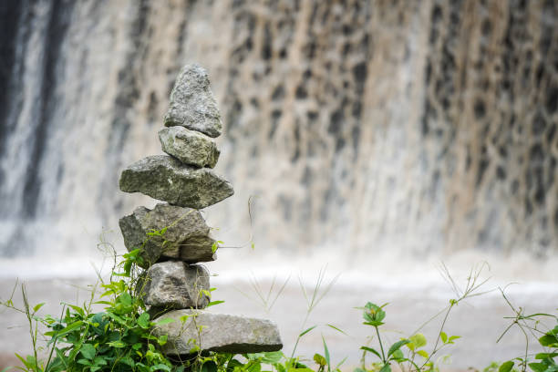 istock Stone tower on waterfall stream background. Rock Balancing or rock stacking hobby in the nature. Empty blank copy text space. 2148355720