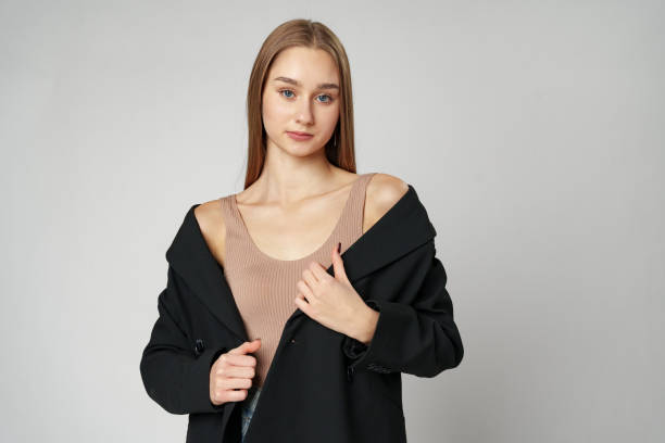 istock Young Woman in Black Jacket Posing to Camera against gray background 2148355749