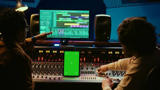 istock Diverse music experts working with greenscreen on tablet and mixing console 2148355808