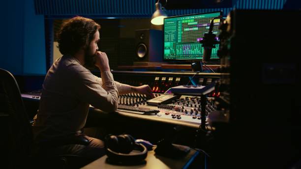 istock Music producer fixing coiled cable inside amplifier or audio compressor 2148355900