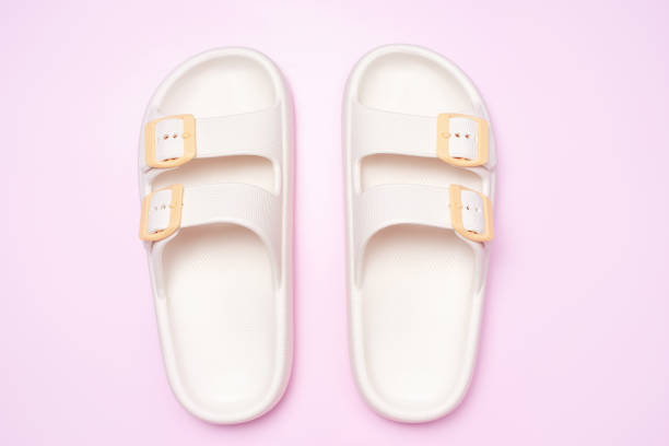 istock Rubber summer flip-flops on pink background close-up, top view. 2148356007