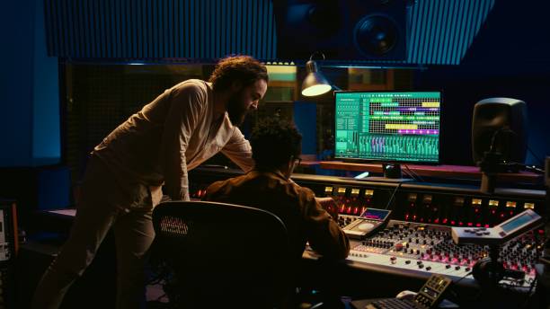 istock Tracking engineer collaborating with musician to edit sounds in control room 2148356091