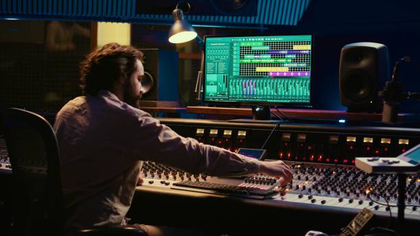 istock Music producer editing sounds with mixing console and switchers 2148356155