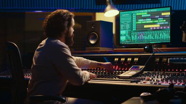 istock Audio technician mixes individual tunes to create balanced sound after recording 2148356314