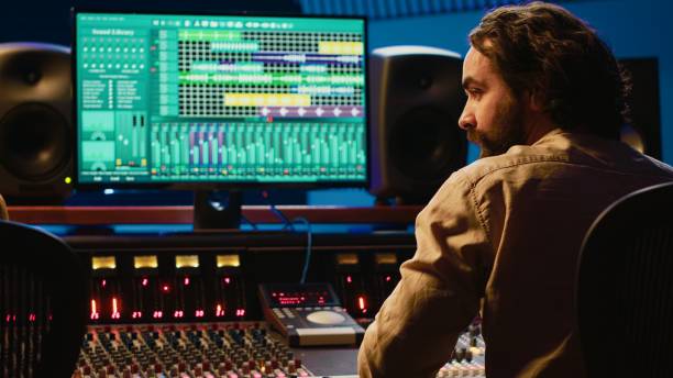istock Team of artist and technician editing audio after recording session 2148356371