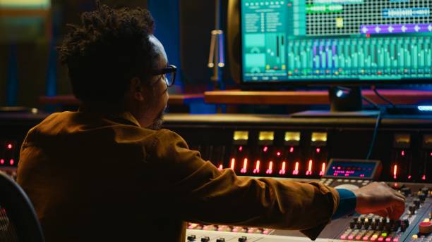 istock African american producer working at mixing panel in recording studio 2148356383