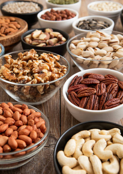 istock Raw walnuts and cashew with almonds and peanuts with organic nuts and seed in various assorted bowls.Macro 2148356442
