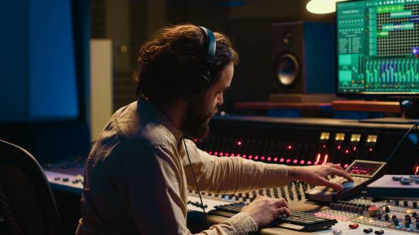 istock Audio expert operating motorized faders and mixing console in control room 2148356449