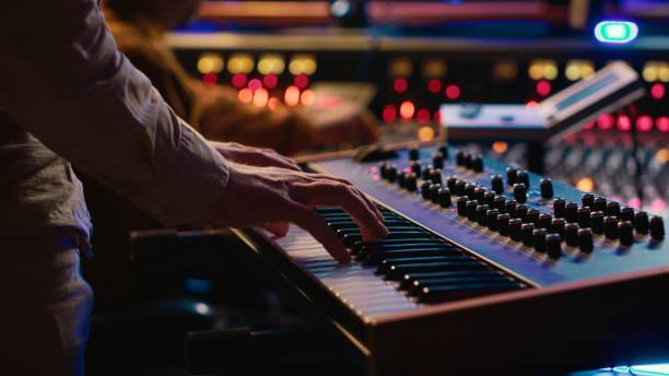 istock Skilled artist playing piano electronic keyboard in control room 2148356565