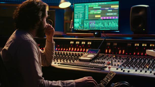 istock Sound designer processing and mixing tunes in control room 2148356595
