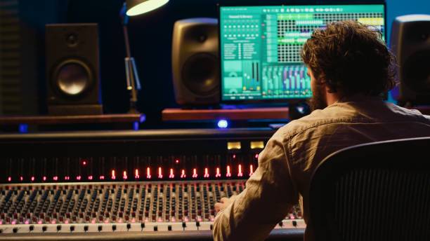 istock Sound engineer recording and editing tracks in control room 2148356714
