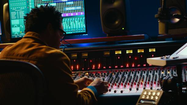 istock African american audio engineer using sound mixing console for managing tracks 2148356766