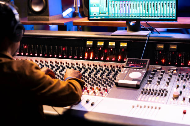 istock African american sound designer operates control room mixer and audio software 2148356872