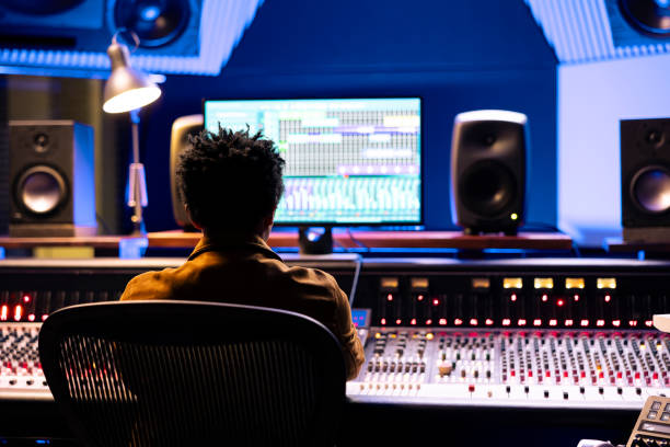 istock African american audio technician recording tracks from sound booth 2148356885