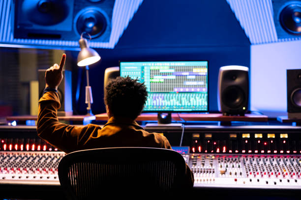 istock Sound engineer counting down to record singer in sound booth 2148356933
