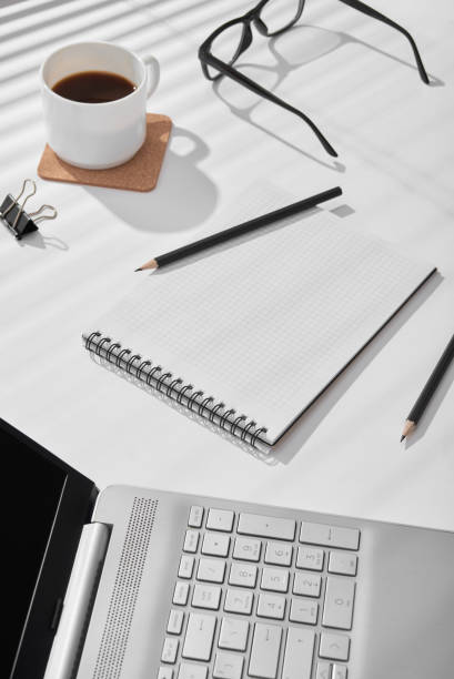 istock On a sunny day, a notepad for notes lies on the table next to pencils and a laptop. 2148356985