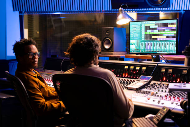 istock Pleased musician and tracking engineer creating a song together 2148357125