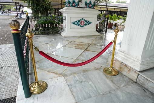 Jogja, Indonesia - January 31, 2024: Stanchions and red velvet rope inside Keraton Yogyakarta also known as Sultan Palace.