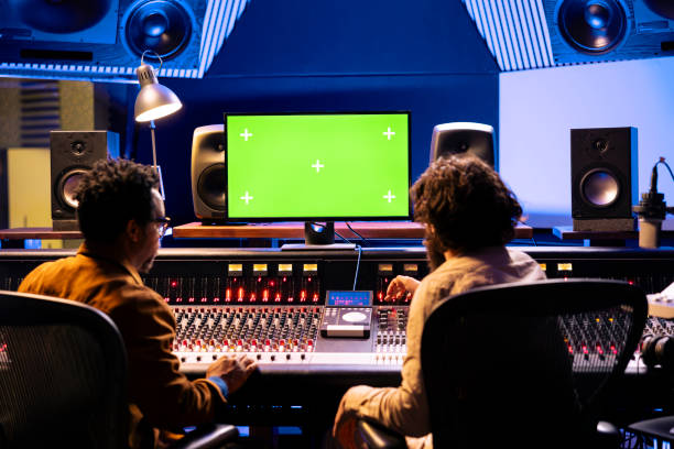 istock Team of artists mixing and mastering music with greenscreen on pc 2148357225