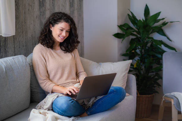 istock Happy woman surfing the net over laptop 2148357231
