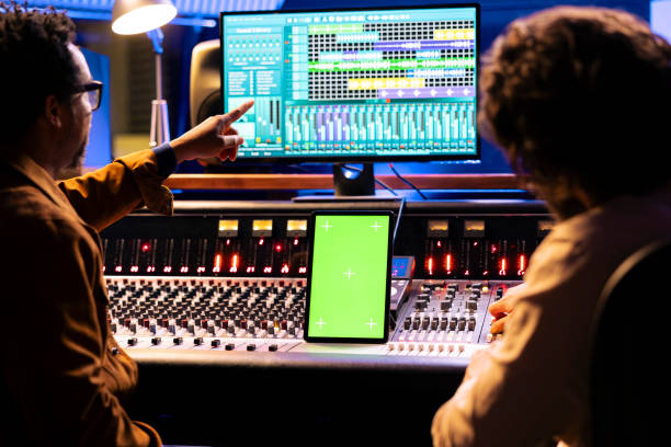 istock Artist and sound engineer working with greenscreen display on tablet 2148357402