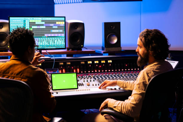 istock Artist and sound engineer working with greenscreen display on tablet 2148357430