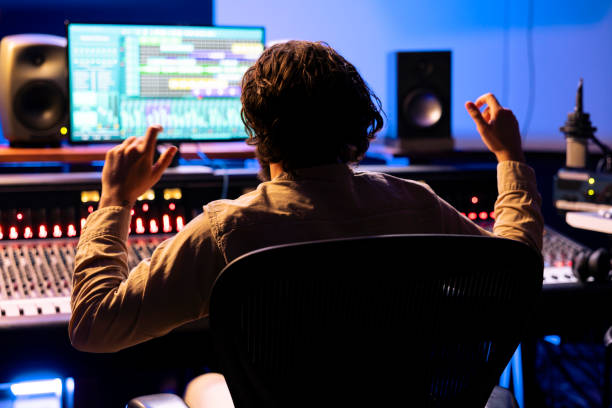 istock Sound engineer dancing around in the studio after listening to recorded tracks 2148357544