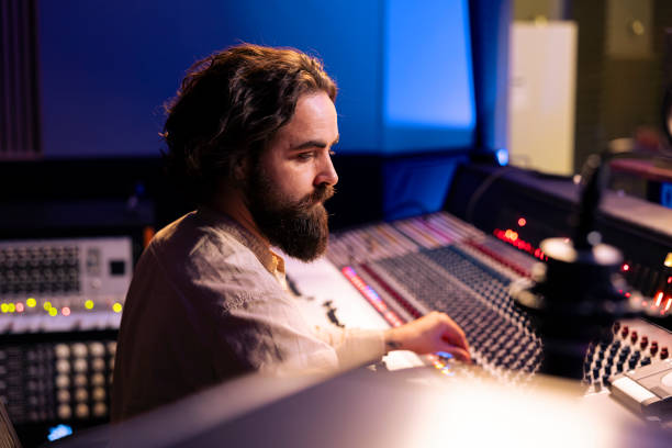 istock Sound producer working on mixing and mastering sounds with pc software 2148357608